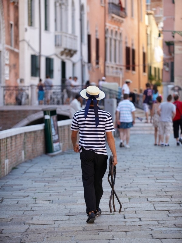 A gondolier walking in Venice